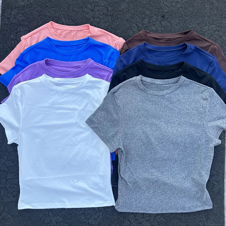 Solid color women's soft breathable yoga short-sleeved comprehensive training tight T-shirt with exposed belly button fitness sh Image principale du produit
